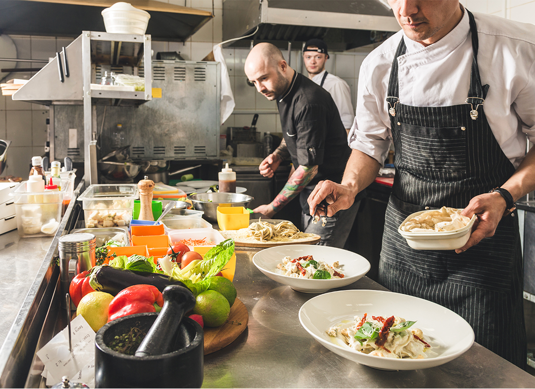 Chefs cooking in a kitchen.